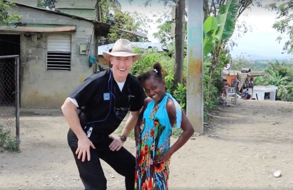 Dr. Sheridan with a young girl during a charity mission trip