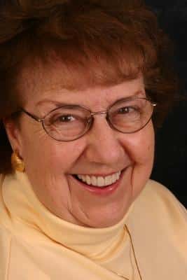 Woman smiles in after treatment photo for porcelain veneers and dental crowns in Grove City