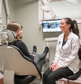 Dental consultation in exam room about anxiety-free dentistry.