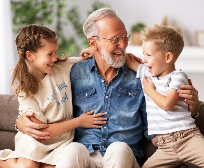 Grandpa with children smiling and happy following dental bridge treatment near Galloway