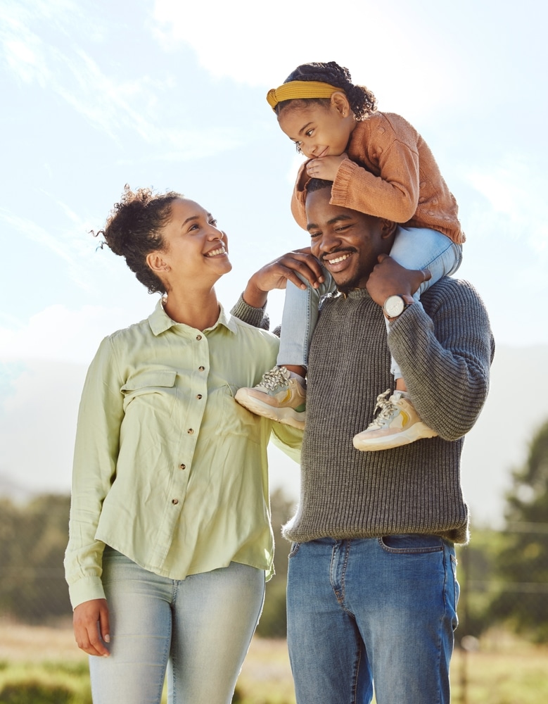 A husband and wife with their child smiling in Galloway, OH