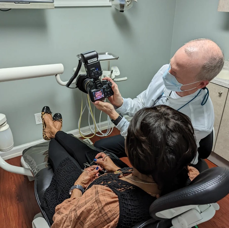 Dr. Sheridan sitting with a patient during an exam.